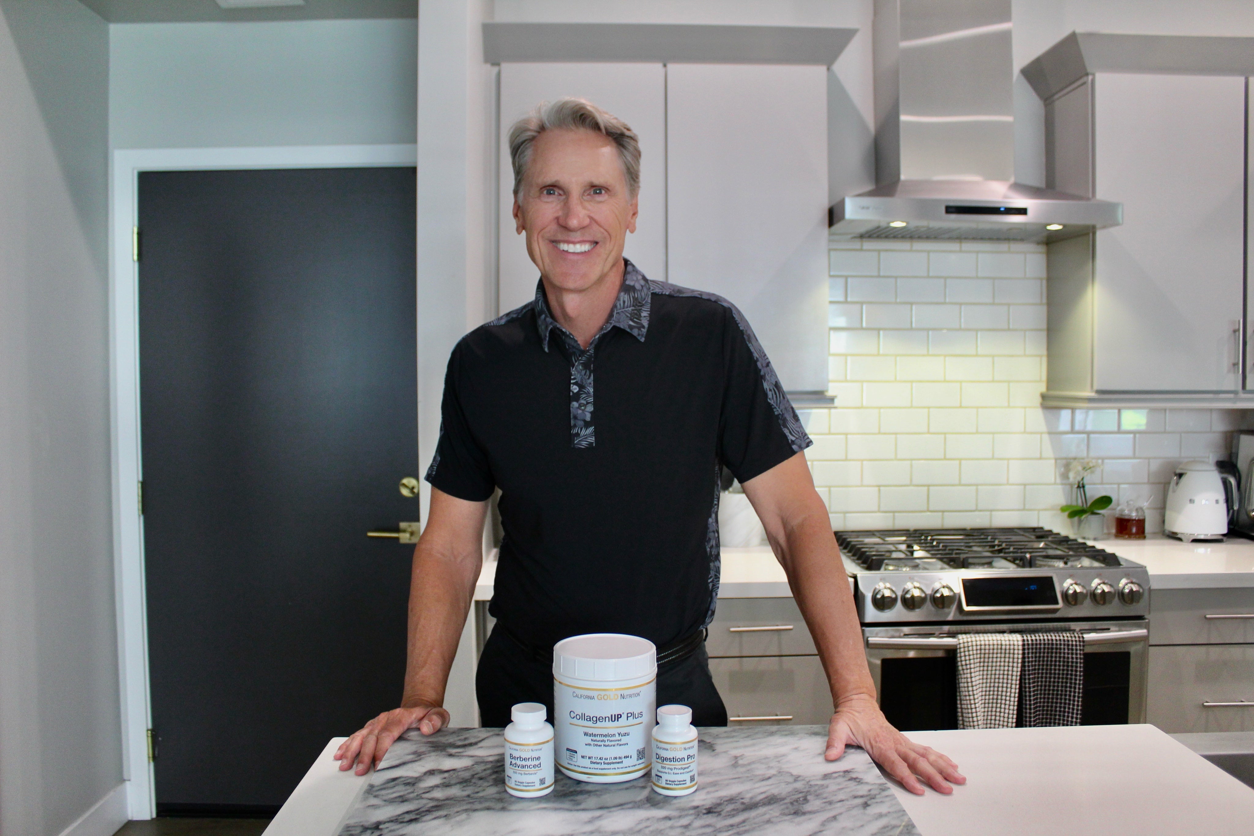 Dr. Murray standing at a kitchen counter and smiling