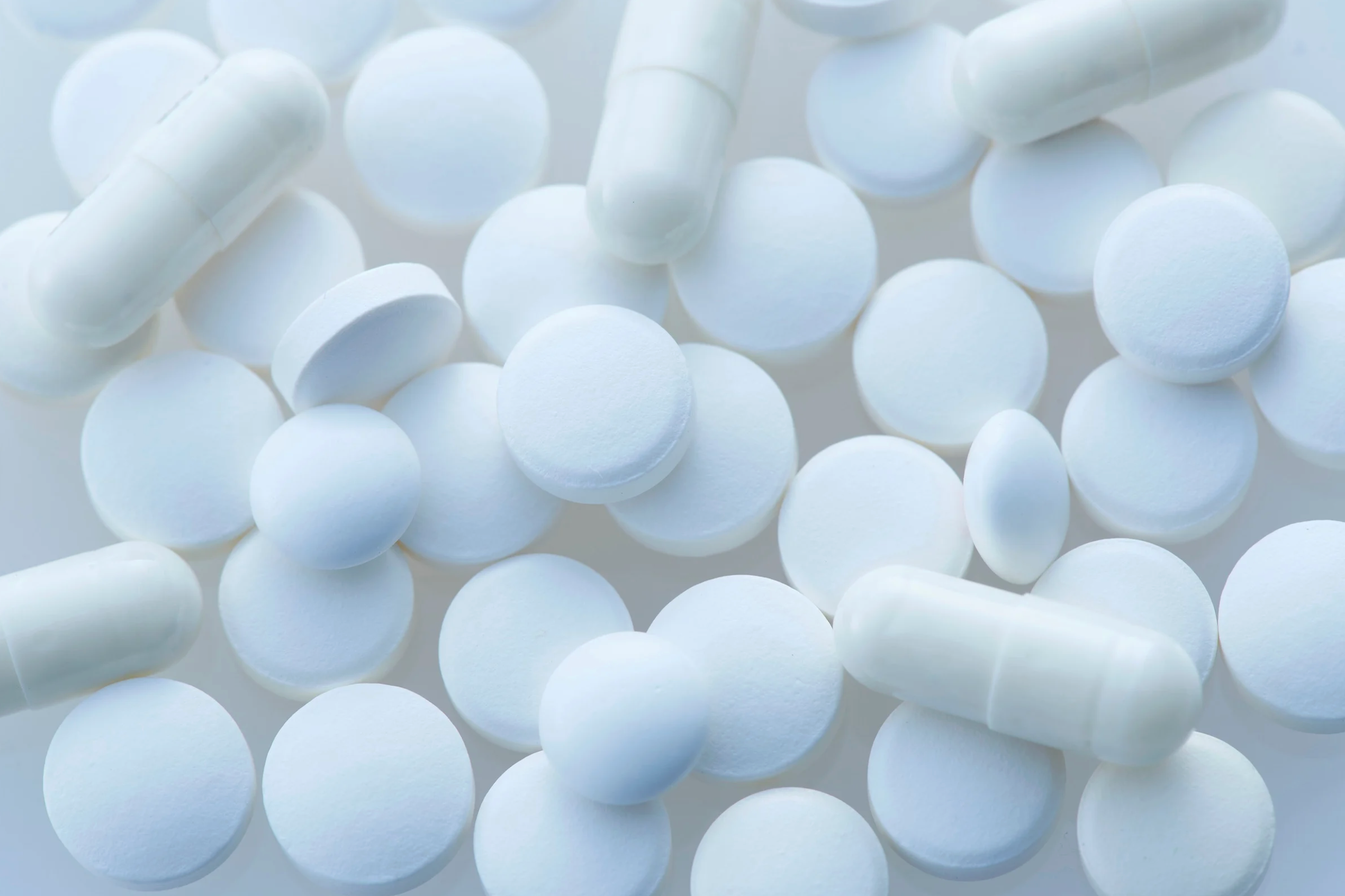 White pills and capsules spread out