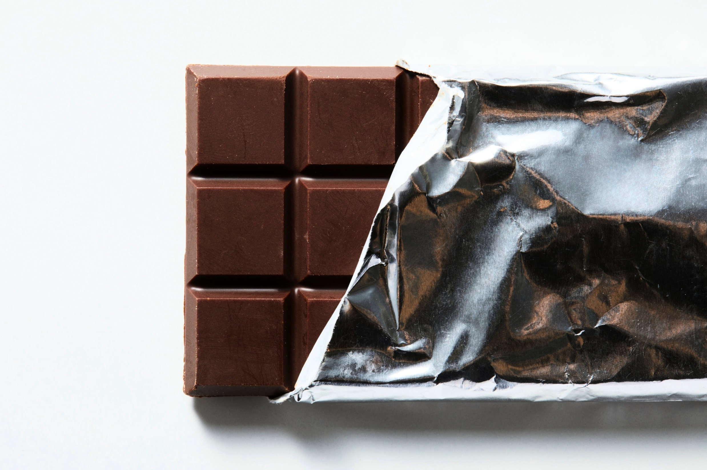 A chocolate bar with it's foil partially pulled back