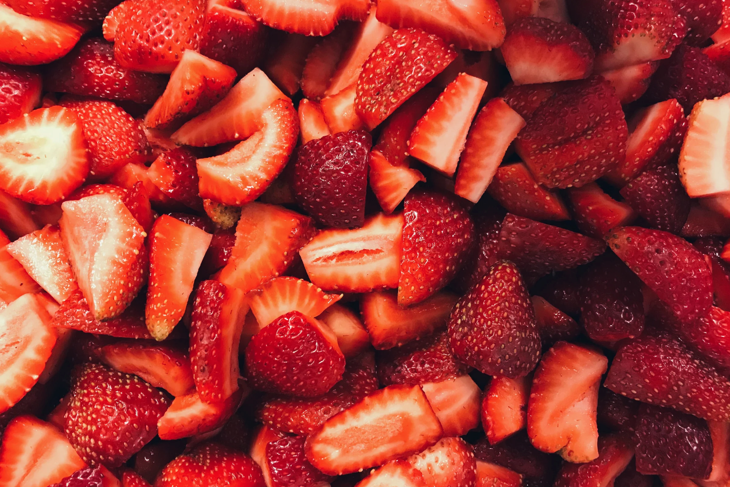 A pile of sliced and cut strawberries