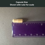 Dr. Murray's DIM Bioperine capsule size shown with a ruler for scale on a gray background