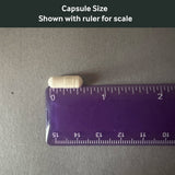 Dr. Murray's Lithium 1 mg capsule size shown with a ruler for scale on a gray background