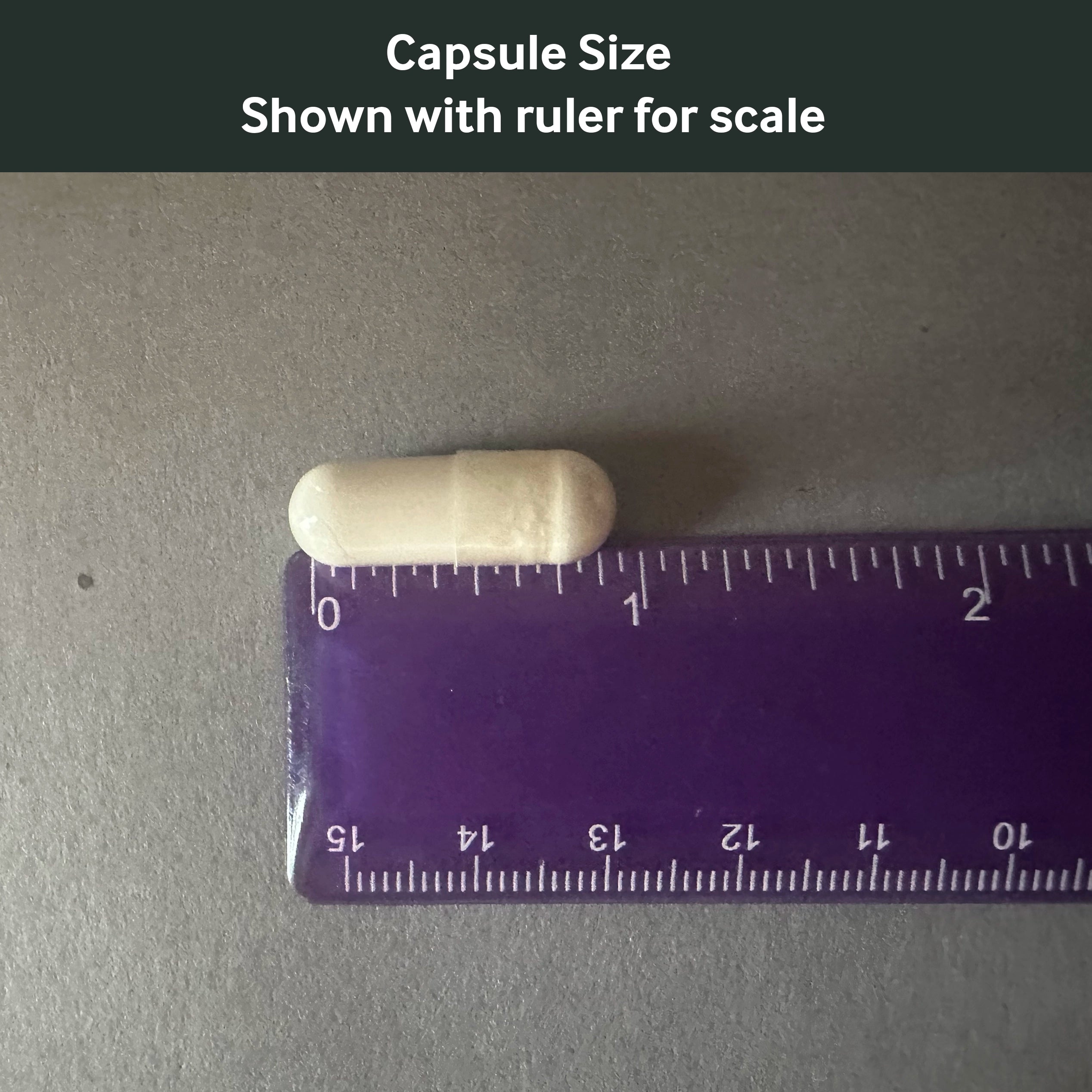 Dr. Murray's Ultra Clean Magnesium Glycinate capsule size shown with a ruler for scale on a gray background