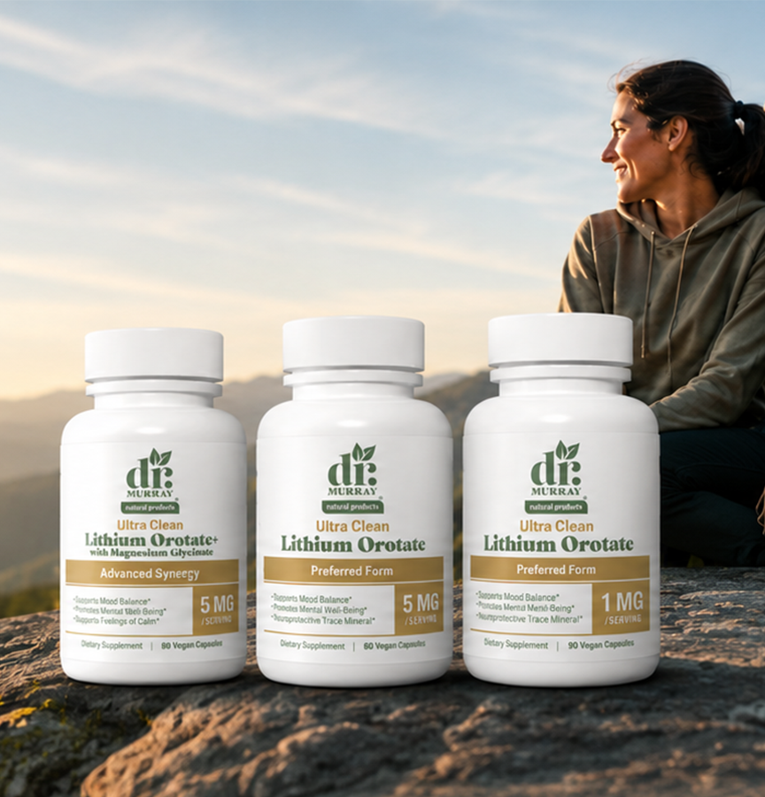 Three white bottles of Dr. Murray Lithium Orotate dietary supplements are lined up on a rocky surface outdoors, with a woman smiling in the background against a sunset sky.