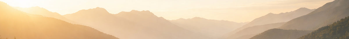 Sunset over a mountain range with warm hues