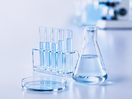 Laboratory setup with test tubes and a beaker on a light background