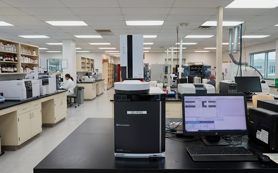 Laboratory setting with scientific equipment and computers.
